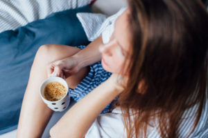 Woman Drinking Coffee In Bed In The Morning
